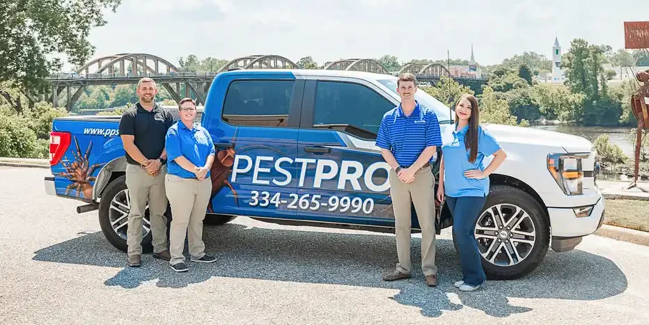 team standing in front of truck