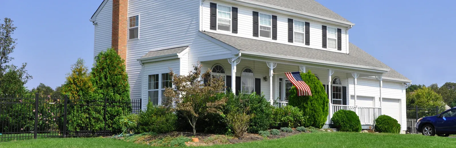 traditional home with american flag on front porch